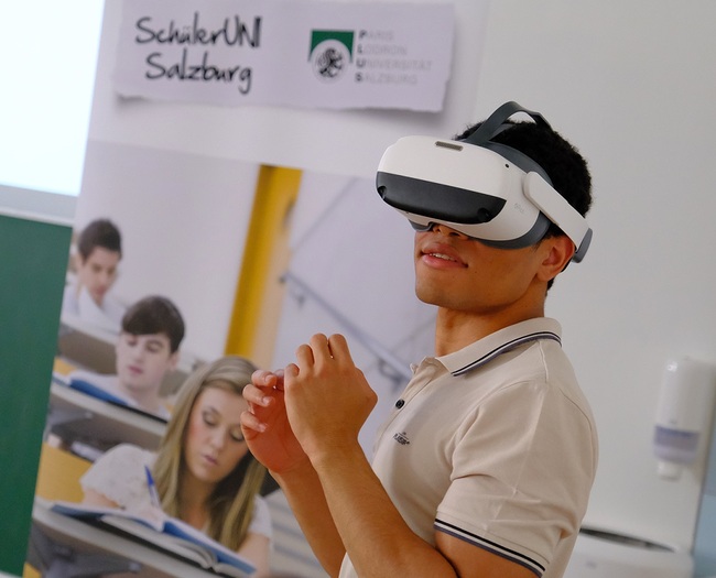 Ein Teilnehmer der Schüler-Uni beim virtuellen „Besuch“ eines Hindu-Tempels. Die moderne Technik der „Virtual Reality“-Brille macht‘s möglich.  