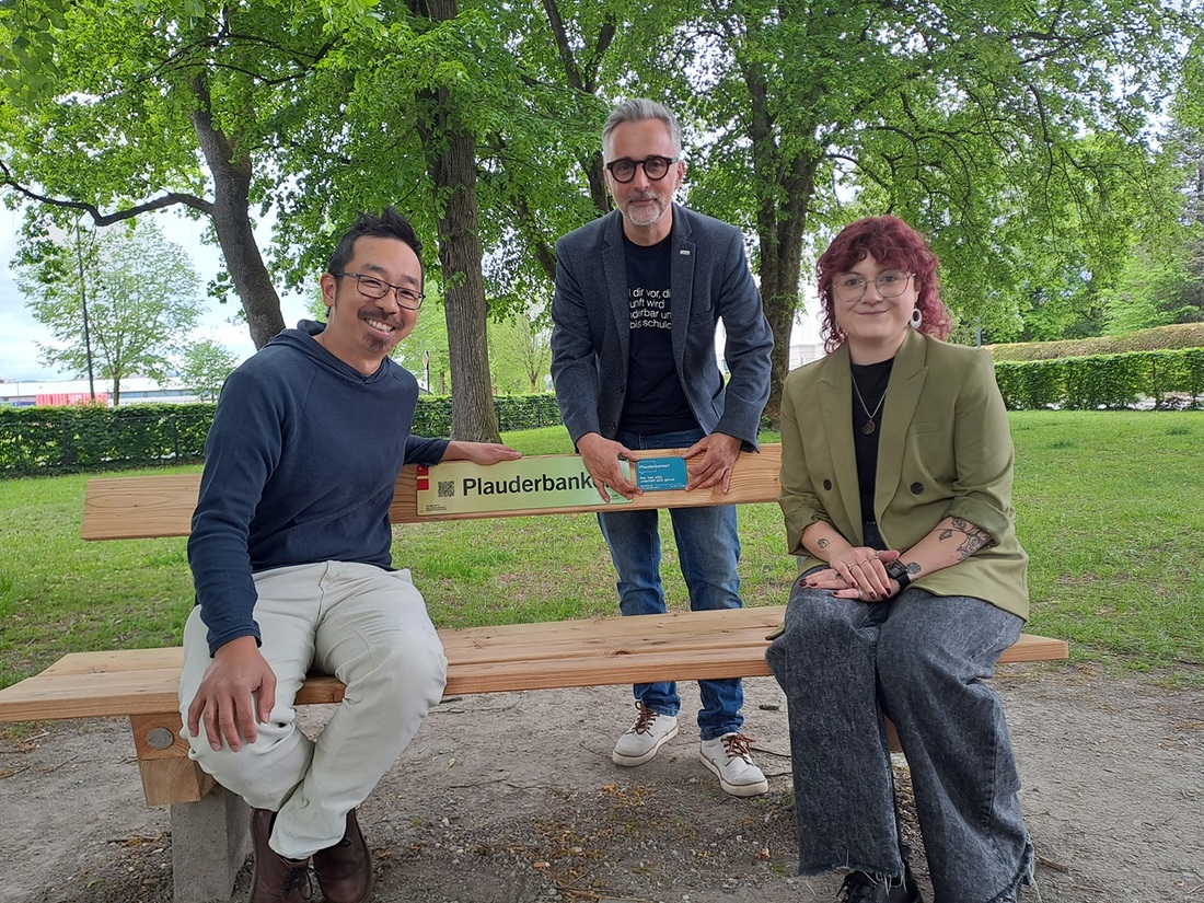 Projektkoordinator Duy Le Pham, Caritas-Salzburg-Direktor Kurt Sonneck und Projektmitarbei­terin Sarah Podratzky (von links) weihen das Plauderbankerl im Salzburger Huemerpark ein. 