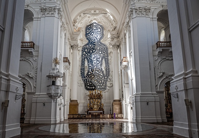  Teil des Kunstwerks ist eine riesige menschliche Silhouette, die über den Köpfen der Besucherinnen und Besucher im Kirchenraum schwebt.