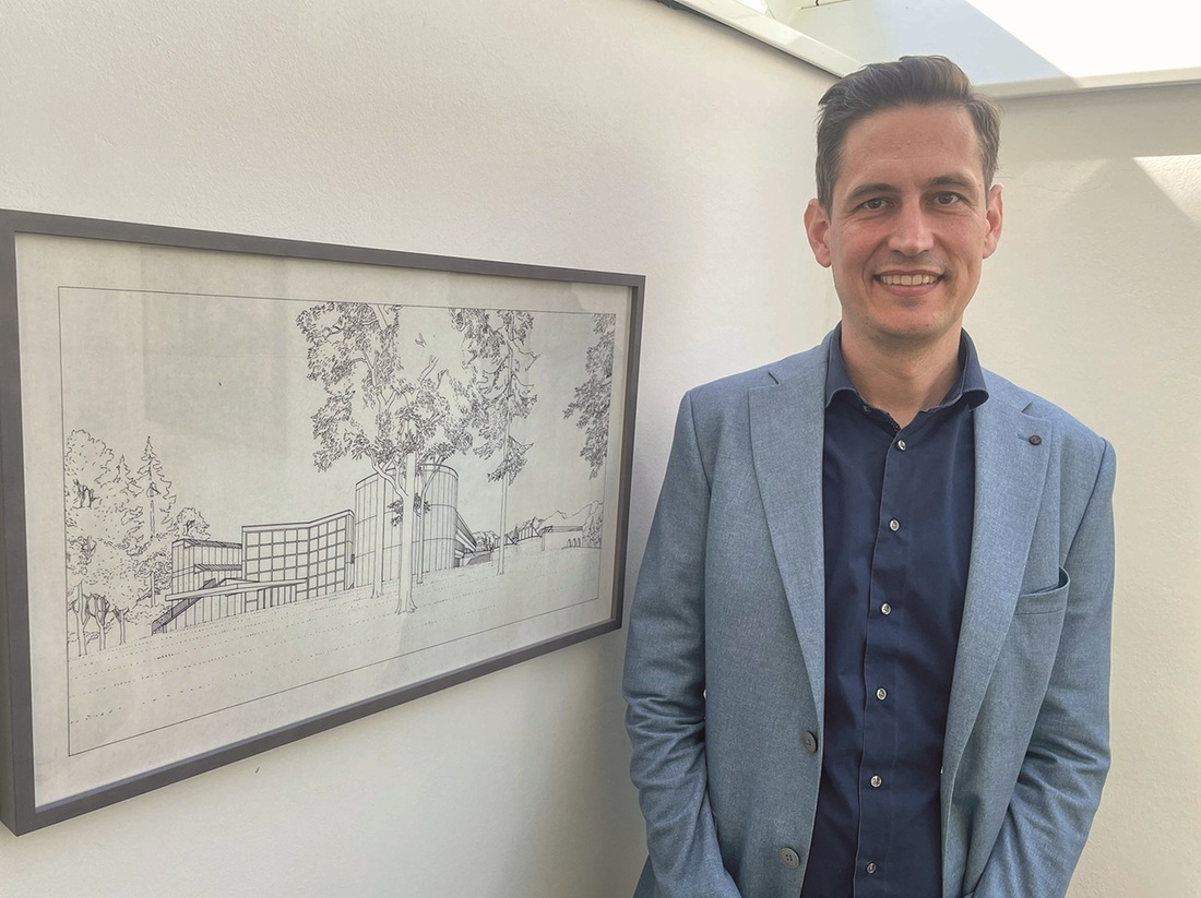 Der „Hausherr“ von St. Virgil: Direktor Jakob Reichenberger  neben einem grafischen Entwurf des Bildungszentrums.