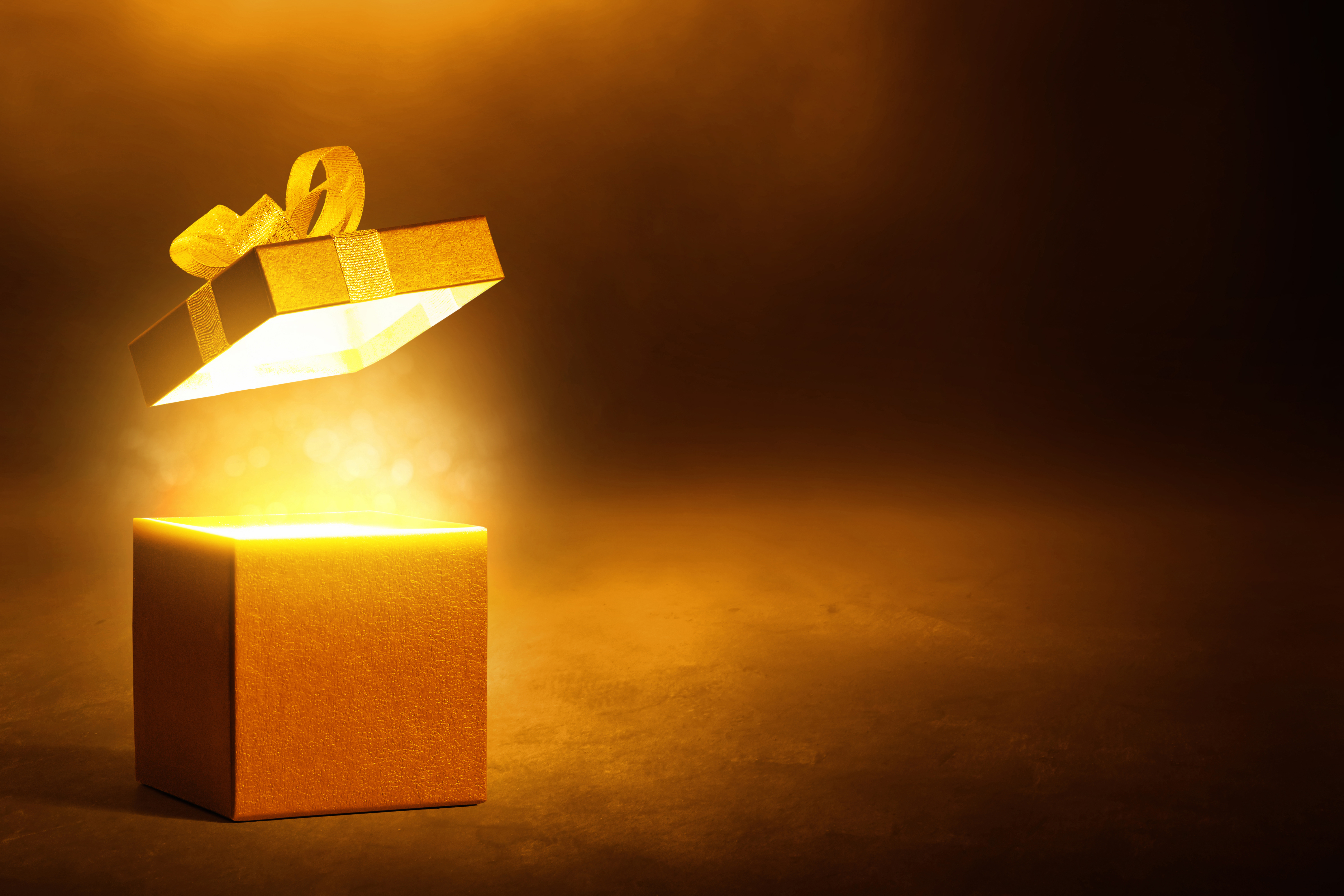 Gold gift box on dark background